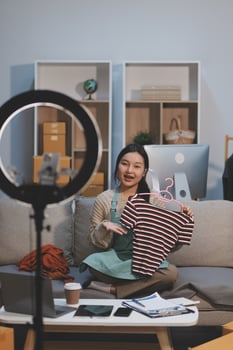 A woman sitting on a couch holding a baby photo