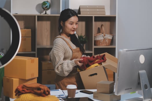 A woman is packing boxes in her office photo