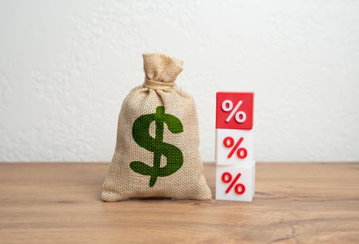 Dollar money bag and interest rates. Income taxes. Interest rates on loans. Fines and fees. Burden of debt, inflation. Personal finance, banking, and macroeconomic shifts. photo