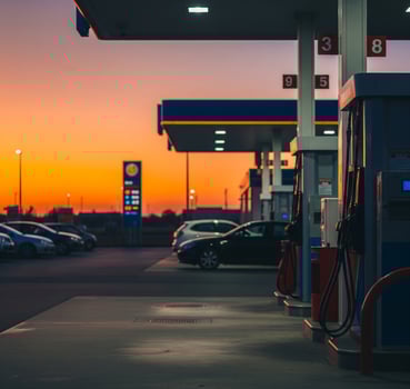 Gas station at sunset with cars filling up with petrol. For energy, travel, infrastructure, climate change and modern technology. photo