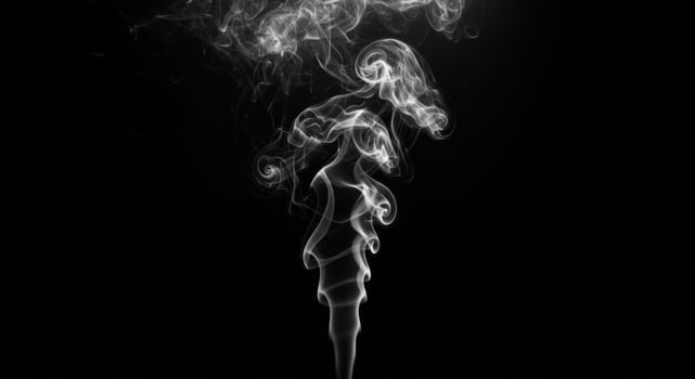 A black smoke and white photo of smoke on a black background