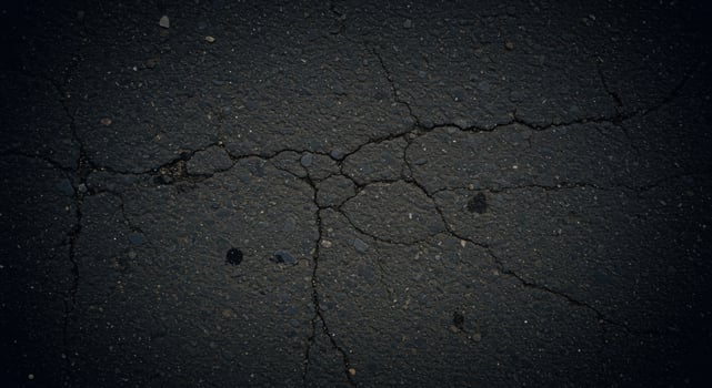 Cracked asphalt background with cracks and cracks photo