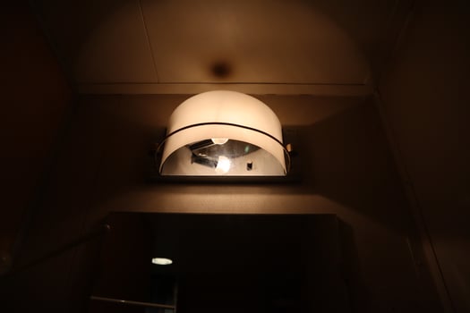 A light is shining on a light fixture in a bathroom photo