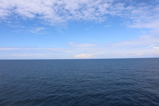 A large body of water with a boat in the middle photo