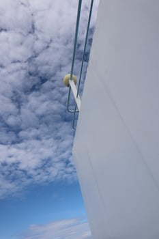 A view of a white building with a blue sky photo