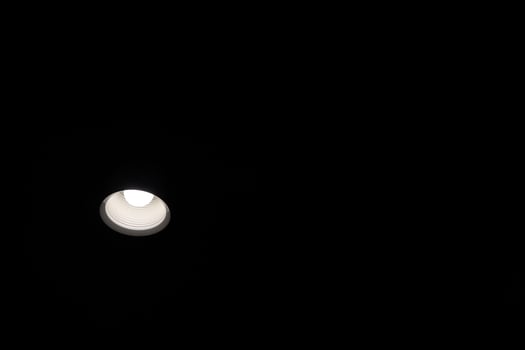 A light bulb is shining in the dark photo