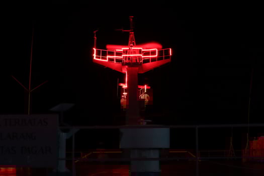 A red light on a tower at night photo