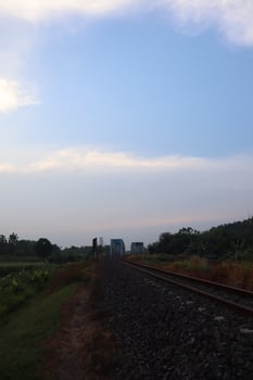A train traveling down a track with a sky in the background photo