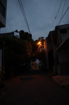 A street light is on a street photo