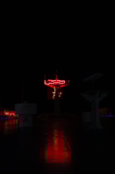 A red neon sign on a dark night photo