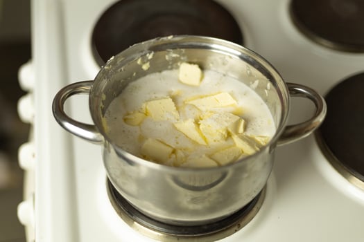 semi-melted butter in a saucepan on the stove photo