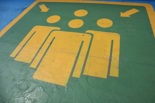 A green and yellow sign with people on it photo