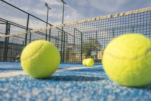 Immersive Low Angle View of a Padel Court with Multiple Balls. photo