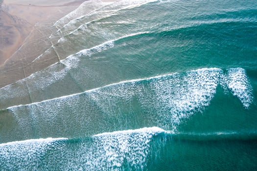 deep sea colors aerial shot of a wild and natural coast, aerial top down view. Marine background photo