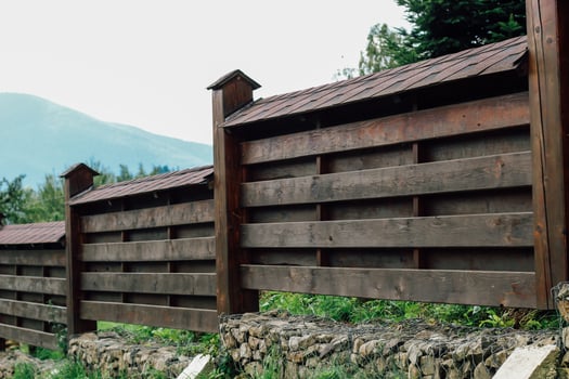 Wooden fence adds charm to rural landscape under cloudy sky photo
