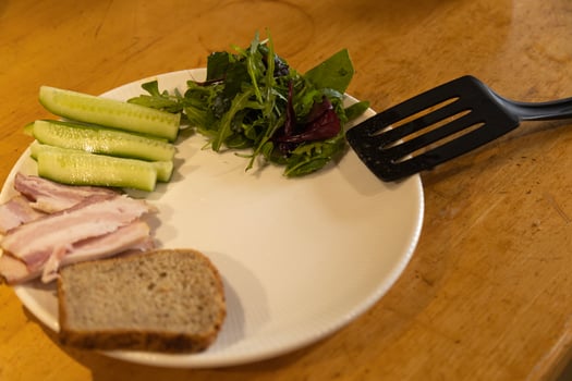 preparing breakfast on a plate meat, greens, cucumbers photo