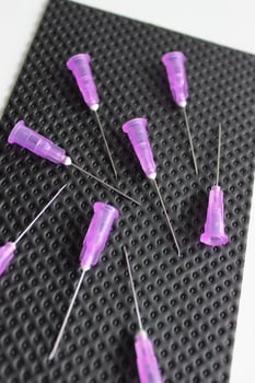 Thin Needles For Vaccine Injection Scattered On Disinfected Napkin photo
