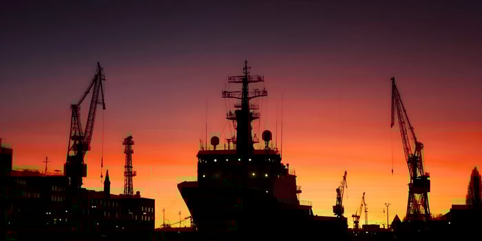Silhouette of Ship at Sunset with Harbor Cranes photo