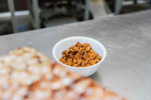 Close up of almonds in a bowl at food processing facility with copy space photo