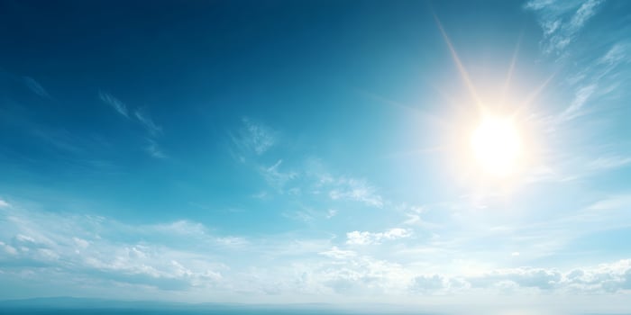 Bright Sun Shining in Blue Sky with White Clouds Landscape photo