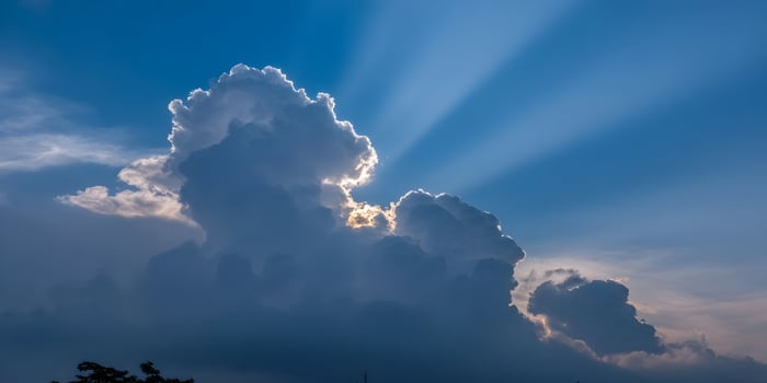 Dramatic Cloudscape Sun Rays Breaking Through Cumulus Clouds Blue Sky photo