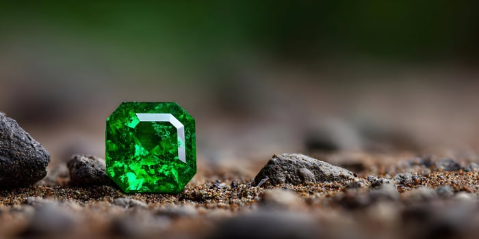Emerald Gemstone on Brown Ground Closeup Photography photo
