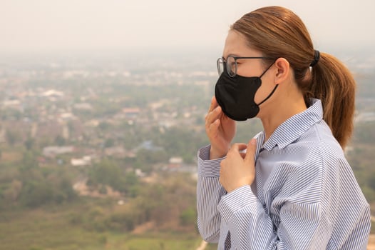 Young Businesswoman coughing becaused of allergy from Bad air pollution. photo