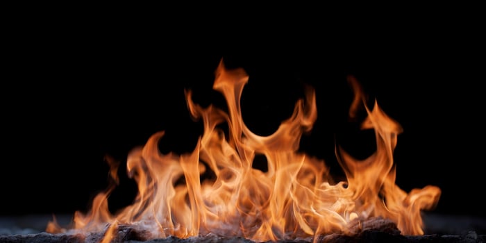 Fiery Orange Flames Burning Bright Against Black Background photo