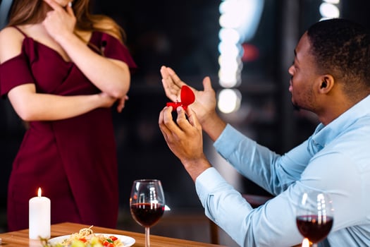 Marry Me. Black Man Making Marriage Proposal To His Girlfriend During Romantic Dinner In Restaurant, Giving Box With Diamond Ring, Doubtful Woman Thinking About Answer, Cropped Image, Selective Focus photo