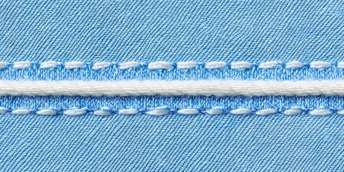 Blue Denim Fabric Texture with White Stitching and Cord photo