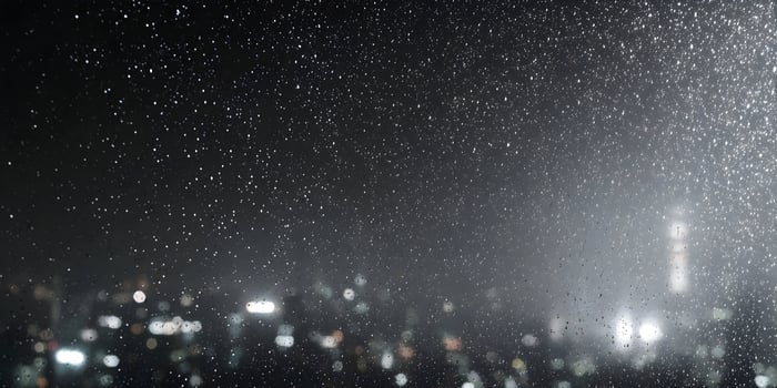 Rainy Night Cityscape View Through Window Raindrops photo