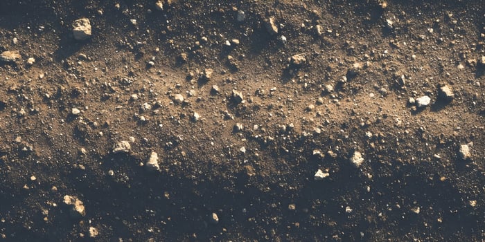 Brown Soil Texture with Small Stones and Rocks Background Image photo