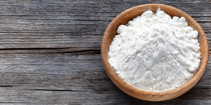 Wooden Bowl of White Flour on Rustic Wooden Table Top photo
