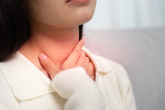 Asian woman put on neck due to a sore throat. female tonsillitis causes a inflammation. treated by taking water, taking antibiotics, consult a doctor, virus., Influenza, flu photo