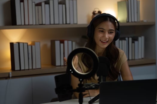 Remote Work and Digital Communication. Engaging woman in headphones conducting a virtual meeting. photo