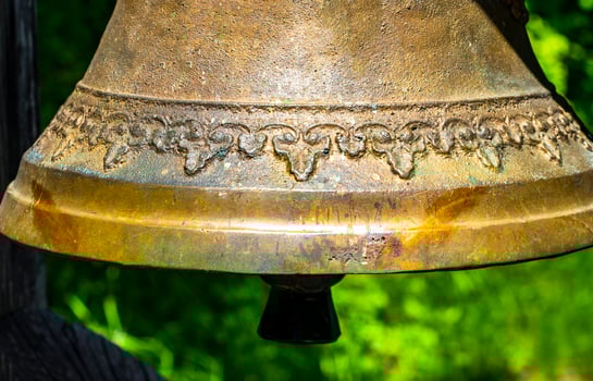 Ringing the Christian bell with green background. photo