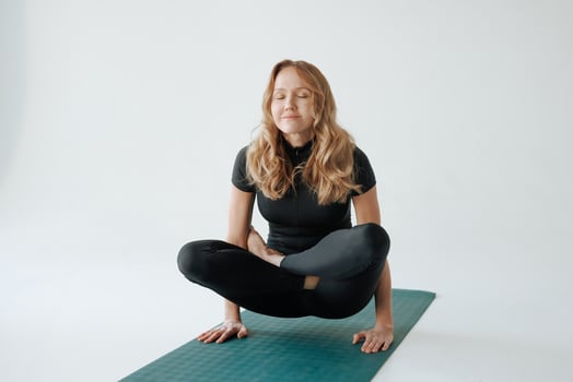 Mature woman practicing yoga pose on mat in studio, balance and strength training for healthy lifestyle photo