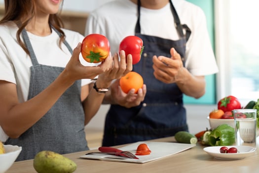 Couple Cooking Together. Joyful partners preparing healthy meals in a modern kitchen. photo
