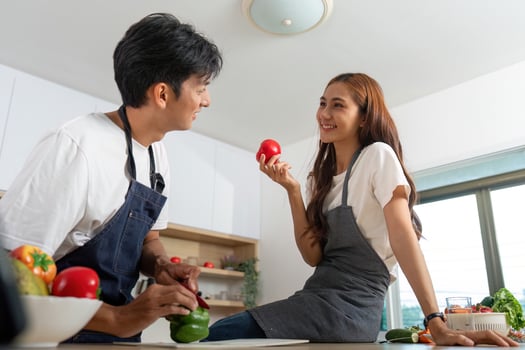 Couple Cooking Together. Happy partners sharing fresh produce in a modern kitchen. photo