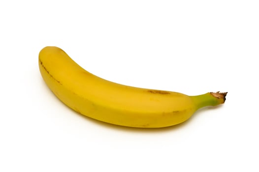 Bright yellow banana resting on a clean surface, showcasing its smooth curve and vibrant color under photo