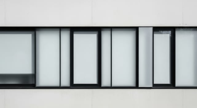 Sleek modern building exterior with black framed frosted glass window design. photo