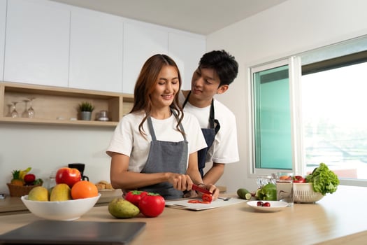 Couple Cooking Together. Smiling While Preparing Fresh Ingredients. photo
