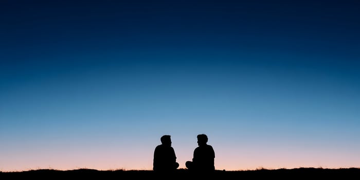 Two Silhouettes Men Sitting Sunset Landscape Sky photo