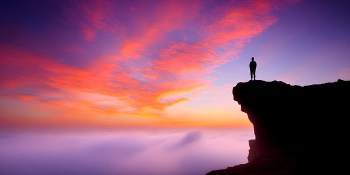 Silhouette Man Clifftop Vibrant Sunset Sky Cloudscape photo