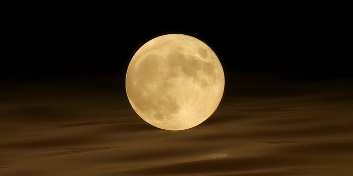 Full Moon over Dark Brown Water Surface Night Scene photo