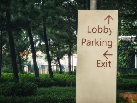 Navigating Directional Signage with Green Trees and Natural Light photo