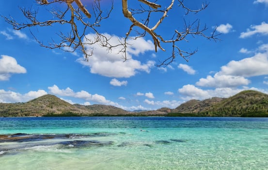 Exploring Tropical Turquoise Waters and Islands Under a Blue Sky with Clouds photo
