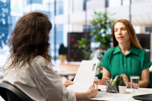 Manager interviewing worker, recruiting for job, discussing business offer in corporate office. Businesswoman hiring candidate after checking CV resume, recruitment concept photo