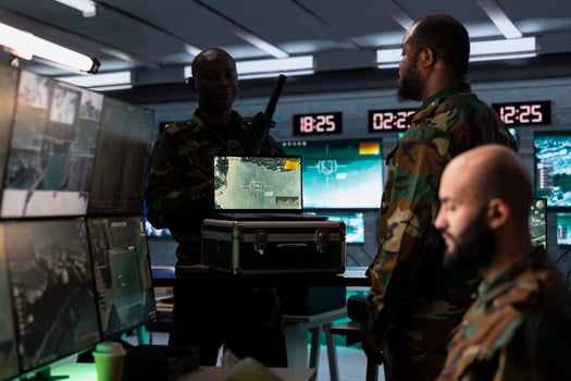 Air defense specialist using radar on laptop to detect missile attacks and conducting space surveillance and satellite tracking. Army expert using military software on notebook preventing rockets photo