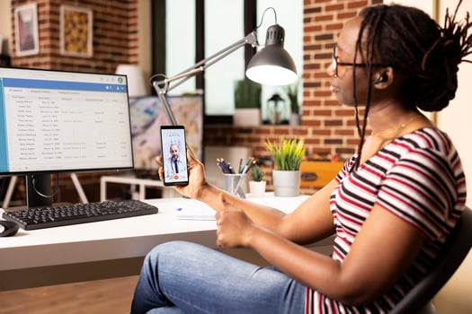 Female data analyst in virtual meeting with caucasian doctor, discussing updates to hospital digital system. Black woman consulting with physician through call during healthcare database session photo